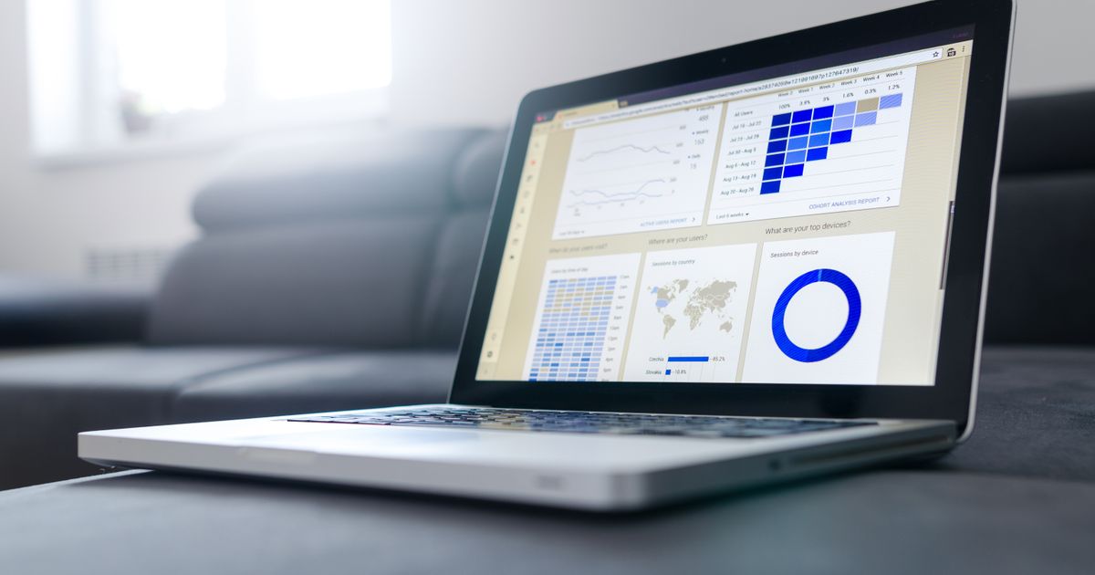 Laptop screen showing an email marketing automation dashboard with performance charts and metrics