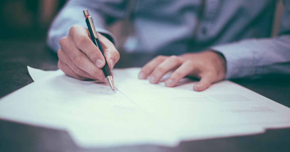 A person's hands filling out a lead capture form on a laptop, representing the friction point of gated content